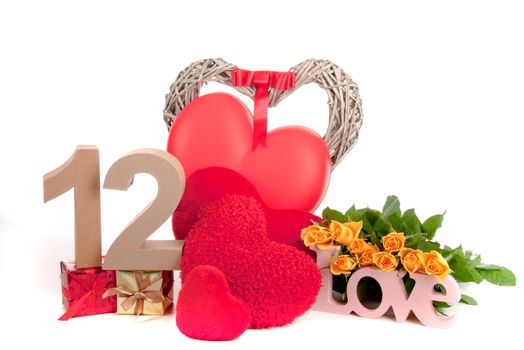 Number of age in a colorful studio setting with heart and gifts and yellow roses