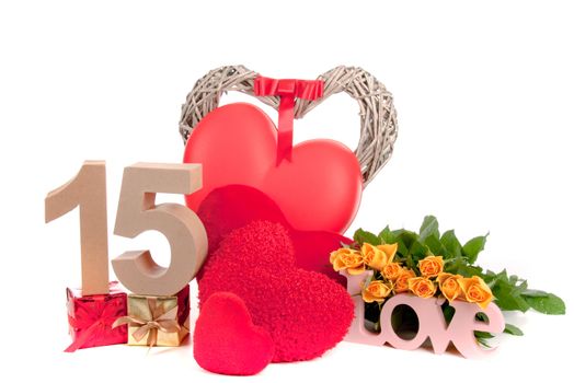 Number of age in a colorful studio setting with heart and gifts and yellow roses