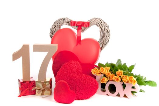 Number of age in a colorful studio setting with heart and gifts and yellow roses