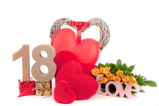 Number of age in a colorful studio setting with heart and gifts and yellow roses