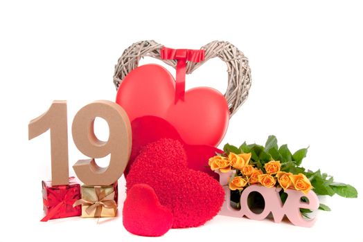 Number of age in a colorful studio setting with heart and gifts and yellow roses