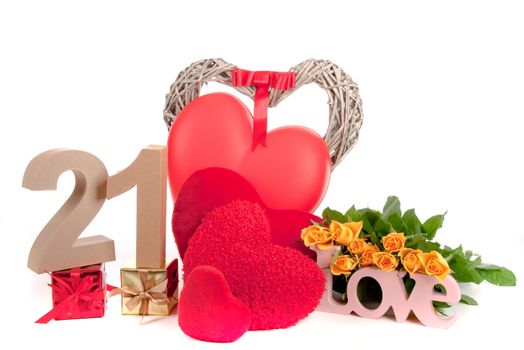 Number of age in a colorful studio setting with heart and gifts and yellow roses