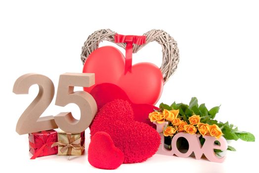 Number of age in a colorful studio setting with heart and gifts and yellow roses