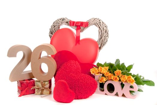 Number of age in a colorful studio setting with heart and gifts and yellow roses