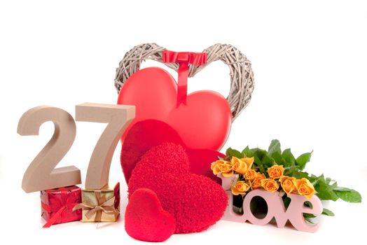 Number of age in a colorful studio setting with heart and gifts and yellow roses