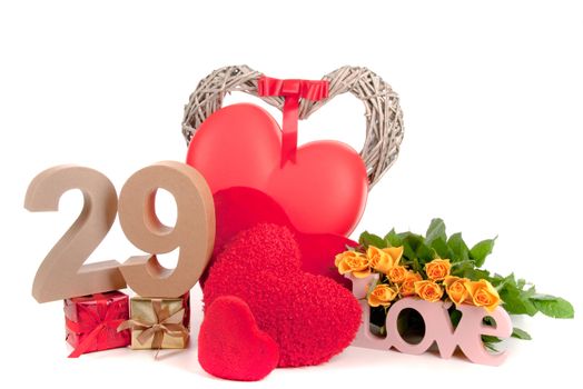 Number of age in a colorful studio setting with heart and gifts and yellow roses