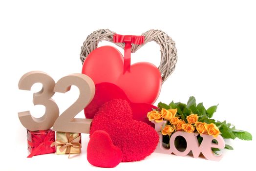 Number of age in a colorful studio setting with heart and gifts and yellow roses