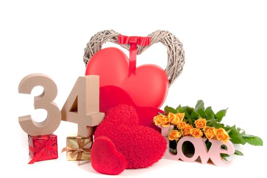 Number of age in a colorful studio setting with heart and gifts and yellow roses