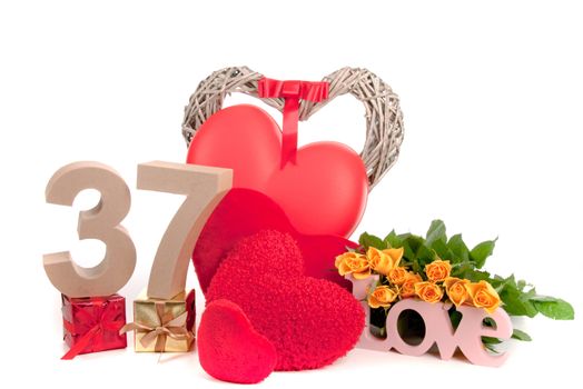Number of age in a colorful studio setting with heart and gifts and yellow roses