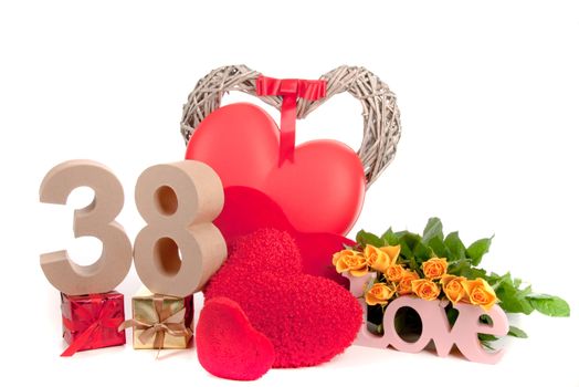 Number of age in a colorful studio setting with heart and gifts and yellow roses