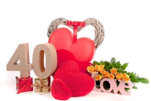 Number of age in a colorful studio setting with heart and gifts and yellow roses