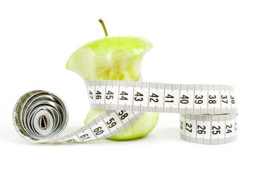 Green bitten apple isolated on white background with measuring tape