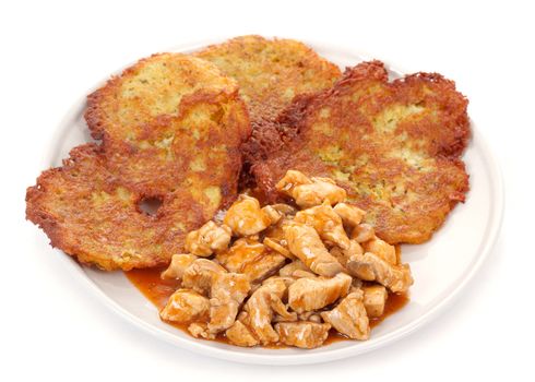 Potato pancakes with chicken meat on white background