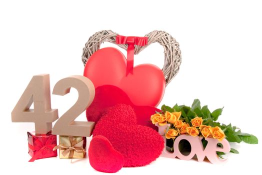 Number of age in a colorful studio setting with heart and gifts and yellow roses