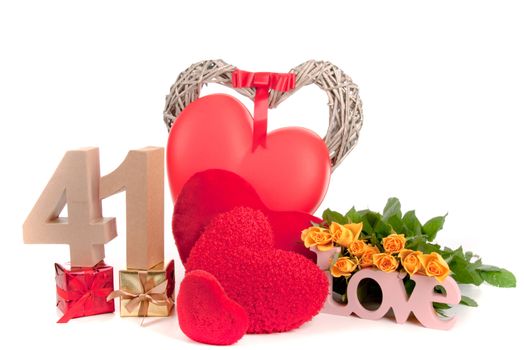 Number of age in a colorful studio setting with heart and gifts and yellow roses