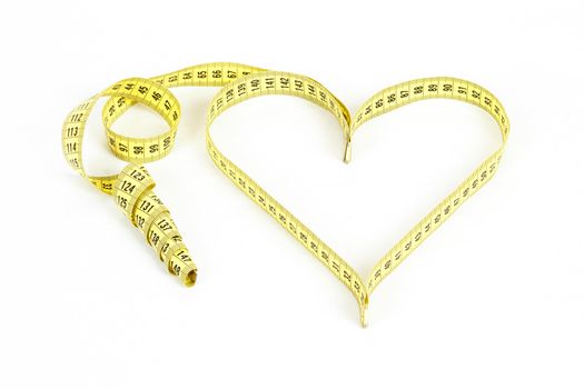 A measuring tape shaping a heart isolated on white background