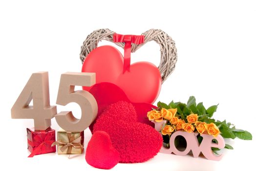 Number of age in a colorful studio setting with heart and gifts and yellow roses