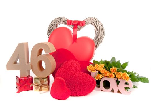 Number of age in a colorful studio setting with heart and gifts and yellow roses