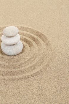 balance zen stones in soft sand with circles