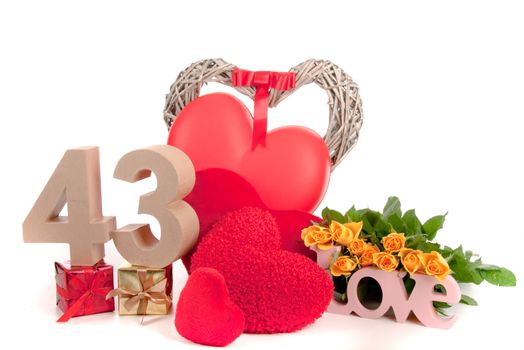 Number of age in a colorful studio setting with heart and gifts and yellow roses