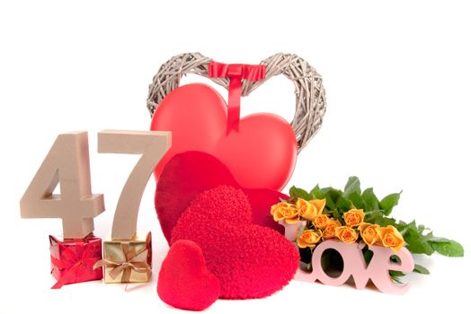 Number of age in a colorful studio setting with heart and gifts and yellow roses