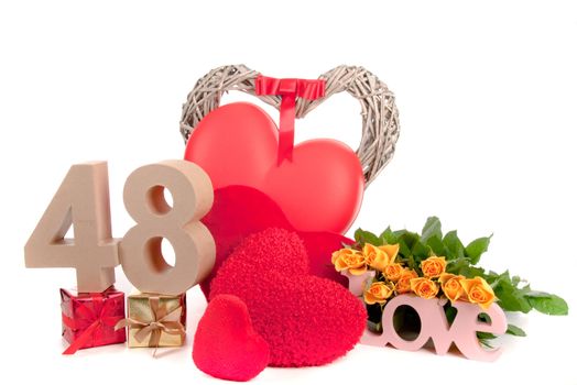 Number of age in a colorful studio setting with heart and gifts and yellow roses