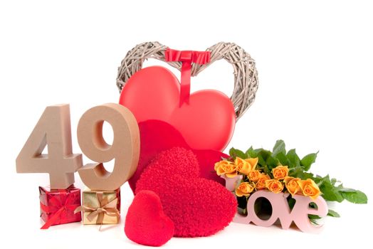 Number of age in a colorful studio setting with heart and gifts and yellow roses