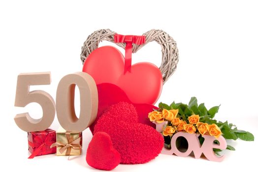 Number of age in a colorful studio setting with heart and gifts and yellow roses