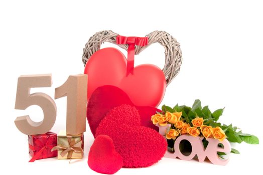 Number of age in a colorful studio setting with heart and gifts and yellow roses