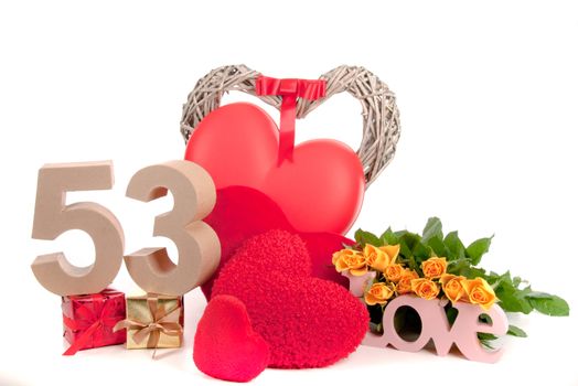 Number of age in a colorful studio setting with heart and gifts and yellow roses