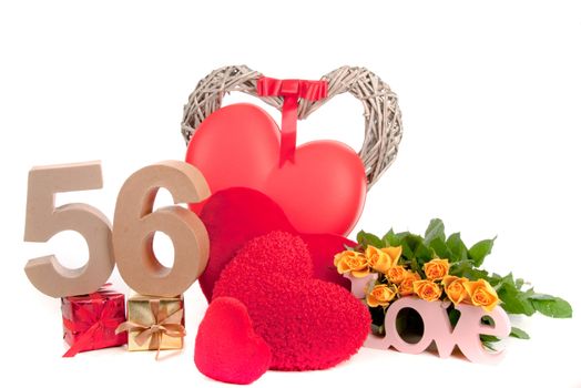 Number of age in a colorful studio setting with heart and gifts and yellow roses