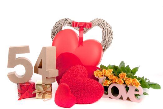 Number of age in a colorful studio setting with heart and gifts and yellow roses