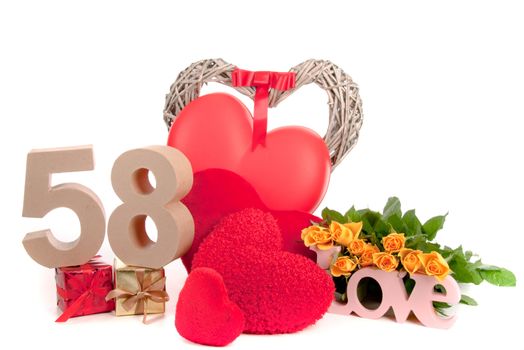 Number of age in a colorful studio setting with heart and gifts and yellow roses