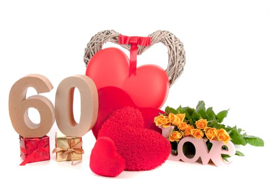 Number of age in a colorful studio setting with heart and gifts and yellow roses