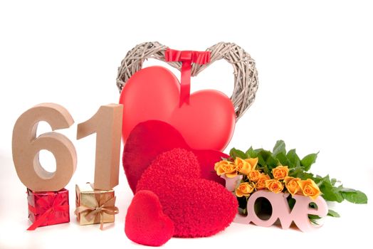 Number of age in a colorful studio setting with heart and gifts and yellow roses
