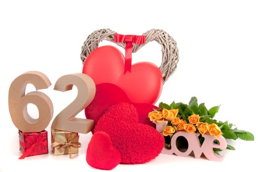 Number of age in a colorful studio setting with heart and gifts and yellow roses