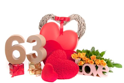 Number of age in a colorful studio setting with heart and gifts and yellow roses