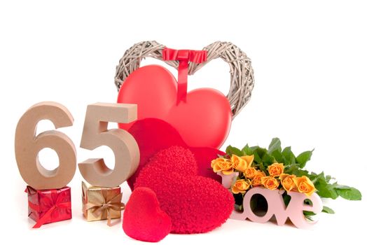 Number of age in a colorful studio setting with heart and gifts and yellow roses