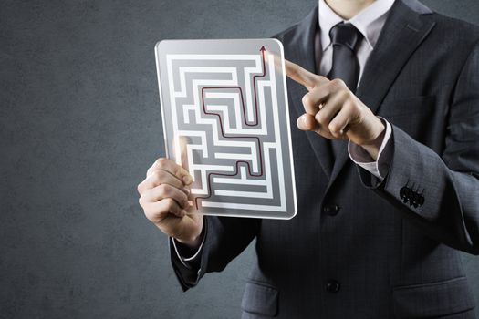 Businessman with solutions of maze