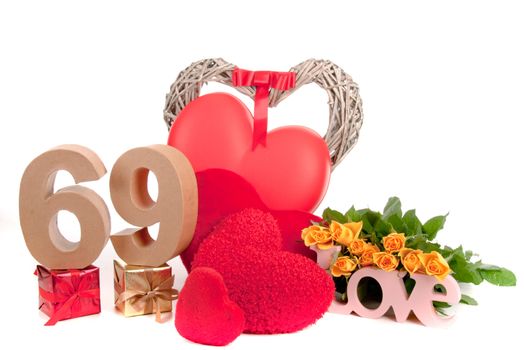 Number of age in a colorful studio setting with heart and gifts and yellow roses