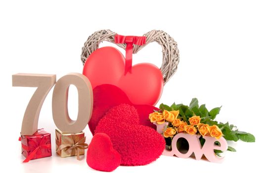 Number of age in a colorful studio setting with heart and gifts and yellow roses