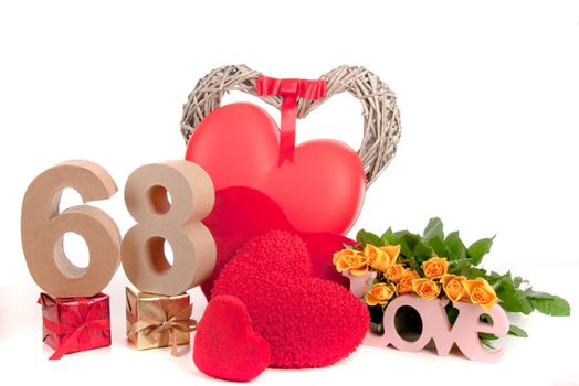 Number of age in a colorful studio setting with heart and gifts and yellow roses