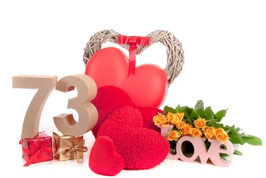 Number of age in a colorful studio setting with heart and gifts and yellow roses