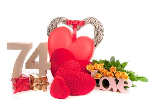 Number of age in a colorful studio setting with heart and gifts and yellow roses
