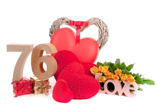 Number of age in a colorful studio setting with heart and gifts and yellow roses