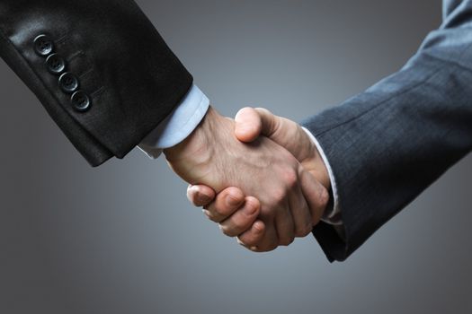 Two business men shaking hands, close up