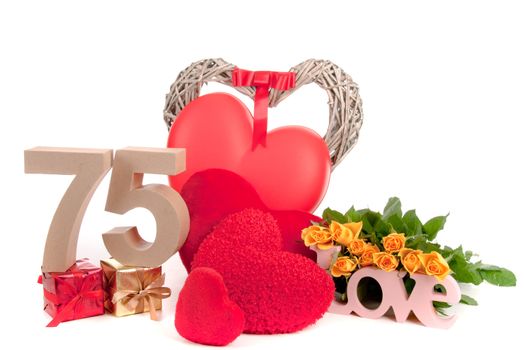 Number of age in a colorful studio setting with heart and gifts and yellow roses