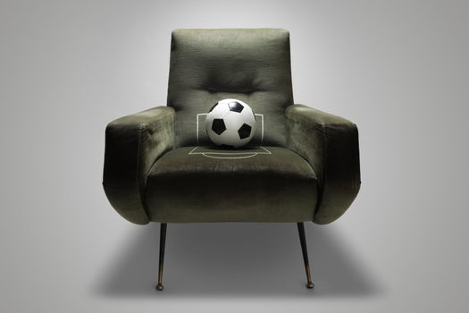Soccer ball on a green chair, conceptual photo