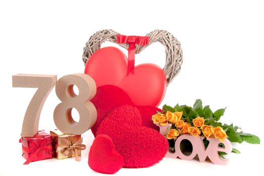 Number of age in a colorful studio setting with heart and gifts and yellow roses