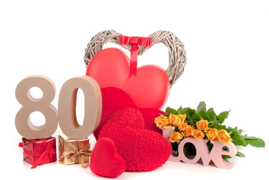 Number of age in a colorful studio setting with heart and gifts and yellow roses